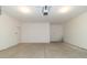 A spacious garage with concrete flooring and a white door leading inside the house at 4408 W Preserve Pass, New Palestine, IN 46163