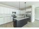 Modern kitchen boasts white cabinets, a stainless steel refrigerator, and granite countertops at 4408 W Preserve Pass, New Palestine, IN 46163