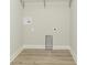 A utility room with washing machine hookups, outlets, and vinyl flooring at 4408 W Preserve Pass, New Palestine, IN 46163