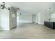 Bright, open-concept living space featuring a kitchen island and wood-look flooring at 4408 W Preserve Pass, New Palestine, IN 46163