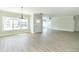 Open concept living room with a large window, neutral walls, and modern gray flooring at 4408 W Preserve Pass, New Palestine, IN 46163