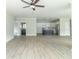 Spacious living room with an open view of a modern kitchen and gray wood-look flooring at 4408 W Preserve Pass, New Palestine, IN 46163