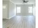 Large, open living room with wood-look floors, white trim, and plenty of natural light at 4408 W Preserve Pass, New Palestine, IN 46163