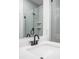 Bathroom featuring quartz counters, black hardware and a glass enclosed shower reflected in the mirror at 447 Leota St, Indianapolis, IN 46203