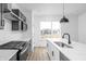 Bright kitchen featuring a large island, modern appliances, and a window view at 447 Leota St, Indianapolis, IN 46203