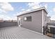 Wide angle of the roof deck showing the wood floor and gray wood siding with a view of the city at 447 Leota St, Indianapolis, IN 46203