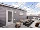 Relaxing roof deck featuring comfortable seating around a modern fire pit and string lights for ambiance at 447 Leota St, Indianapolis, IN 46203