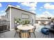 Cozy rooftop deck area with comfortable seating, a dining table, container plants and scenic views at 447 Leota St, Indianapolis, IN 46203