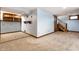 Unfinished basement with carpet, wooden shelving, and access to stairs to upper level at 4644 Cornelius Ave, Indianapolis, IN 46208
