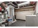 Unfinished basement utility area featuring plumbing, duct work, and a washing machine at 4644 Cornelius Ave, Indianapolis, IN 46208