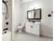 Modern bathroom featuring a walk-in shower, white vanity, and tiled floor at 4644 Cornelius Ave, Indianapolis, IN 46208
