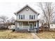 Charming two-story home with blue shutters, covered front porch, and inviting curb appeal at 4644 Cornelius Ave, Indianapolis, IN 46208
