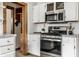 Contemporary kitchen featuring stainless steel appliances, white cabinets, and a stylish microwave at 4644 Cornelius Ave, Indianapolis, IN 46208