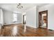 Spacious living room with wood floors, decorative ceiling, large window, and plenty of natural light at 4644 Cornelius Ave, Indianapolis, IN 46208