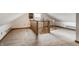 Open loft area with plush carpeting, wooden railing, and natural light from window at 4644 Cornelius Ave, Indianapolis, IN 46208