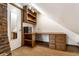 Attic office features custom wood shelving, a built-in desk, and a secure safe at 4644 Cornelius Ave, Indianapolis, IN 46208