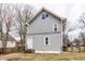 Gray two-story home featuring a white door, black stairs, and a fenced yard at 4644 Cornelius Ave, Indianapolis, IN 46208