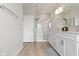Bright bathroom showcasing double sinks, shower stall, and neutral tile flooring at 517 Steinbeck Pl, Carmel, IN 46032
