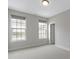 Well-lit bedroom with neutral walls, carpet, two windows and white trim at 517 Steinbeck Pl, Carmel, IN 46032