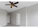 Bright bedroom with a ceiling fan, neutral walls, and two white doors at 517 Steinbeck Pl, Carmel, IN 46032