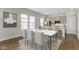 Elegant dining area with a marble-top table, seamlessly connected to a modern kitchen at 517 Steinbeck Pl, Carmel, IN 46032