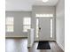 Bright entryway featuring hardwood floors, white trim, and a white front door at 517 Steinbeck Pl, Carmel, IN 46032
