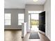 Bright entryway featuring hardwood floors, white trim, and a view of the outdoors at 517 Steinbeck Pl, Carmel, IN 46032