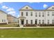 Charming two-story townhome featuring a well-manicured lawn and classic architectural details at 517 Steinbeck Pl, Carmel, IN 46032
