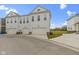 Charming, new three-story townhome featuring attached garages, a pristine white exterior and manicured lawns at 517 Steinbeck Pl, Carmel, IN 46032