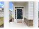 Charming entryway with brick accents, elegant columns, and a welcoming front door at 517 Steinbeck Pl, Carmel, IN 46032