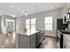 Spacious kitchen island featuring stainless steel appliances and bright natural light at 517 Steinbeck Pl, Carmel, IN 46032