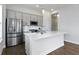 Well-lit kitchen with stainless steel appliances, quartz countertops, and gray cabinetry at 517 Steinbeck Pl, Carmel, IN 46032
