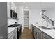 Contemporary kitchen features stainless appliances, gray cabinets, and white subway tile backsplash at 517 Steinbeck Pl, Carmel, IN 46032