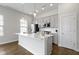 Modern kitchen featuring stainless steel appliances, white cabinets and a large island at 517 Steinbeck Pl, Carmel, IN 46032