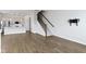 Open-concept living space with hardwood floors and seamless flow to kitchen at 517 Steinbeck Pl, Carmel, IN 46032