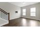 Spacious living room with hardwood floors, natural light, and staircase at 517 Steinbeck Pl, Carmel, IN 46032