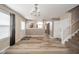 Inviting entryway leading to the kitchen and staircase with wood-look flooring at 556 Gibson Dr, Westfield, IN 46074