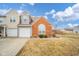 Charming townhouse showcasing a brick facade, attached garage, and manicured landscaping at 556 Gibson Dr, Westfield, IN 46074