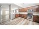 Well-lit kitchen features stainless steel appliances and wood cabinets at 556 Gibson Dr, Westfield, IN 46074