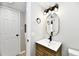 Bathroom featuring a modern vanity, gold accents, decorative mirror and stylish light fixture at 6251 Kelsey Dr, Indianapolis, IN 46268