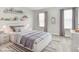 Bedroom with a cozy rug, decorative shelves, and windows with natural light at 6251 Kelsey Dr, Indianapolis, IN 46268