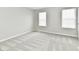 Well-lit bedroom with two windows and neutral carpeting, offering a versatile space at 6251 Kelsey Dr, Indianapolis, IN 46268