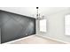 Modern dining room with striking accent wall, chandelier, and bright window at 6251 Kelsey Dr, Indianapolis, IN 46268