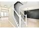 Inviting hallway with modern light fixtures and staircase leading to the upper level at 6251 Kelsey Dr, Indianapolis, IN 46268