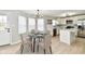 Bright eat-in kitchen featuring white cabinets, countertops, island and stainless steel appliances at 6251 Kelsey Dr, Indianapolis, IN 46268