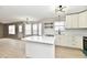 Bright kitchen featuring white cabinets, countertops, island and stainless steel appliances at 6251 Kelsey Dr, Indianapolis, IN 46268