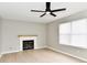 Cozy living room featuring a fireplace, ceiling fan and natural light from a double window at 6251 Kelsey Dr, Indianapolis, IN 46268