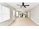 Open-concept living space featuring light wood floors, lots of windows and a view into the modern kitchen at 6251 Kelsey Dr, Indianapolis, IN 46268