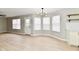 Open-concept living space featuring light wood floors, lots of windows and a modern light fixture at 6251 Kelsey Dr, Indianapolis, IN 46268