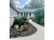 Landscaped walkway leading to the entrance with flower beds and shrubbery at 6466 Kingswood Dr, Indianapolis, IN 46256
